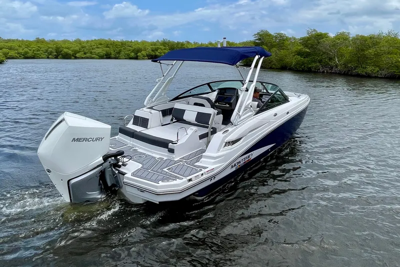 Slide: The Image of 2024 Monterey M-45 boat cruising on a serene lake with lush greenery. - 2