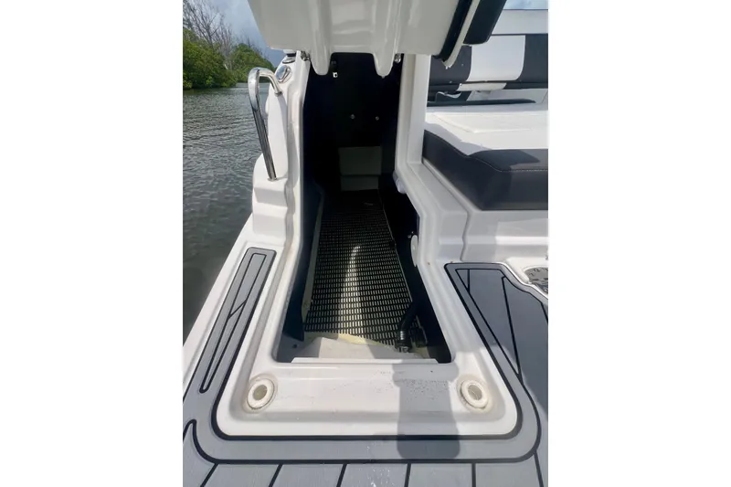 Slide: The Image of 2024 Monterey M-45 boat interior with open hatch, showcasing sleek design and water view. - 23