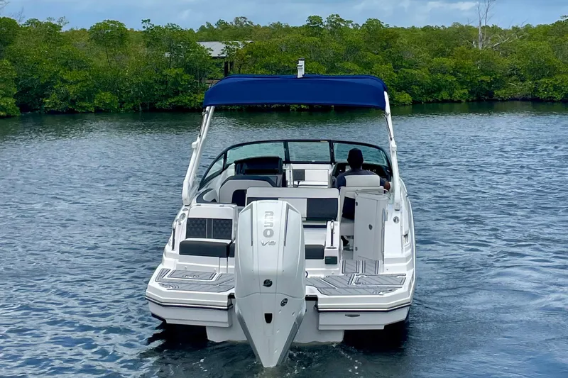 Slide: The Image of 2024 Monterey M-45 boat cruising on a calm river with lush greenery. - 3