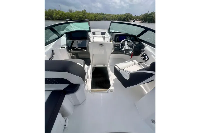 Slide: The Image of 2024 Monterey M-45 boat interior with sleek seating and modern dashboard on a sunny day. - 6