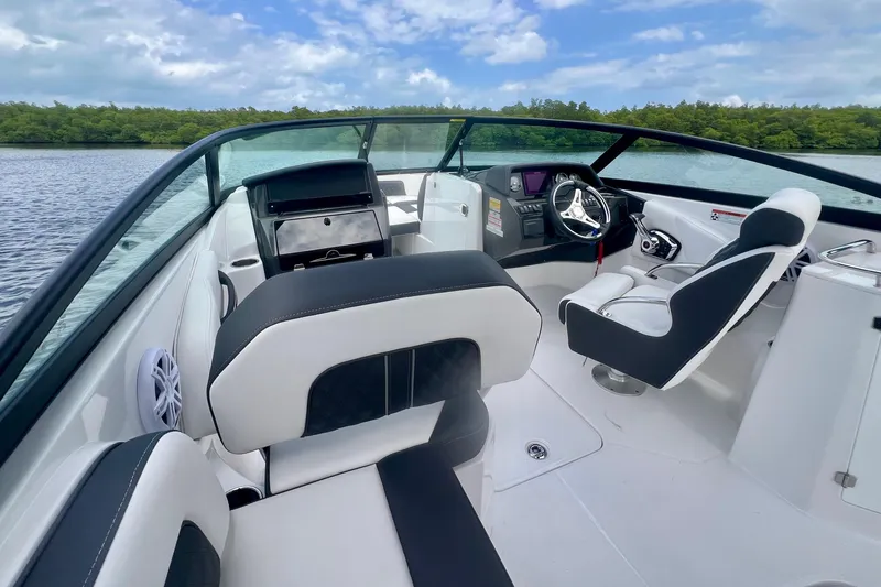 Slide: The Image of 2024 Monterey M-45 boat interior with sleek seating and modern dashboard on a calm lake. - 8