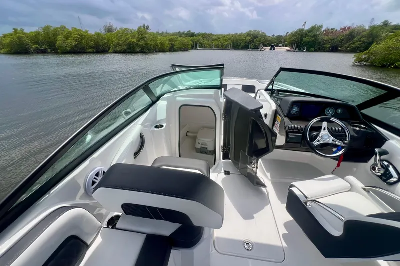 Slide: The Image of 2024 Monterey M-45 boat interior with sleek design and modern dashboard on a calm lake. - 9