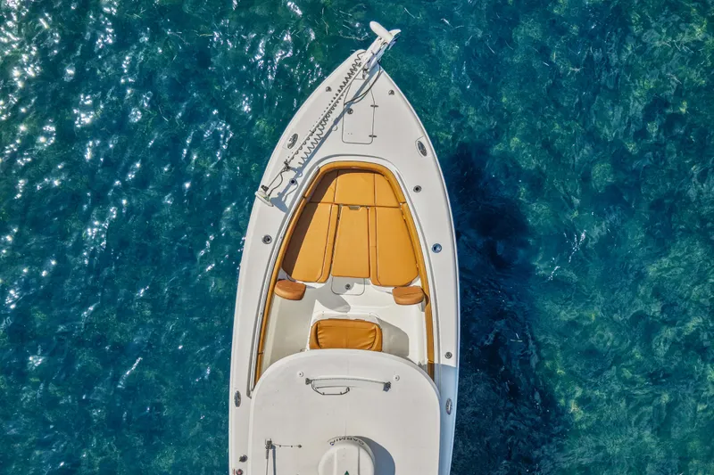 Slide: The Image of 2022 Sea Hunt Gamefish 30 boat with forward seating on clear blue water. - 12