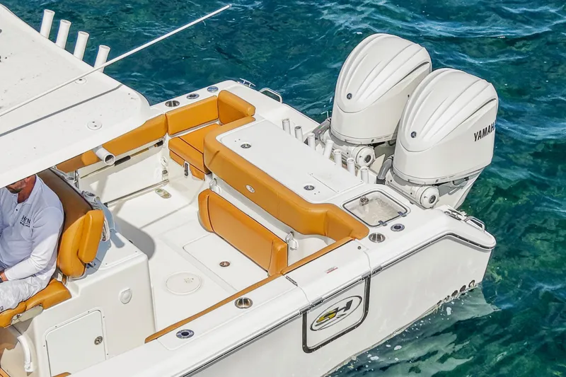 Slide: The Image of 2022 Sea Hunt Gamefish 30 boat with Yamaha engines, featuring forward seating and tan upholstery. - 14