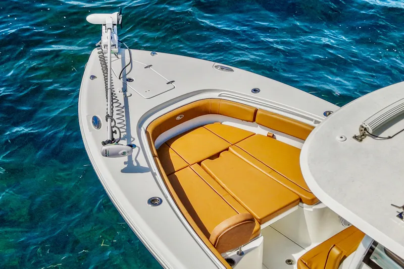 Slide: The Image of 2022 Sea Hunt Gamefish 30 boat with forward seating on clear blue water. - 17