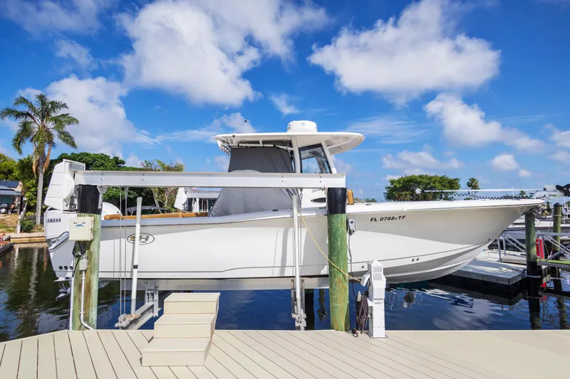 Slide: The Image of 2022 Sea Hunt Gamefish 30 boat docked under blue sky. - 18