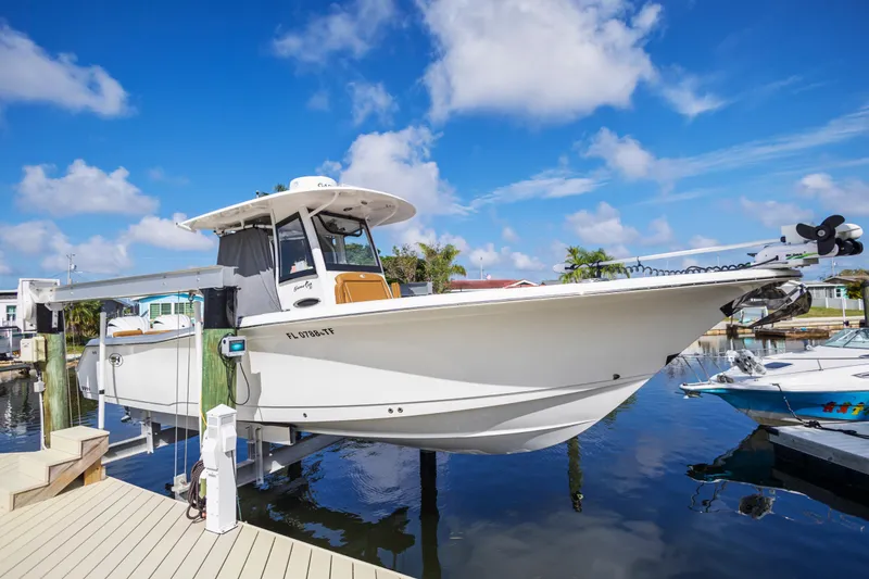 Slide: The Image of 2022 Sea Hunt Gamefish 30 boat docked, featuring forward seating and sleek design. - 19
