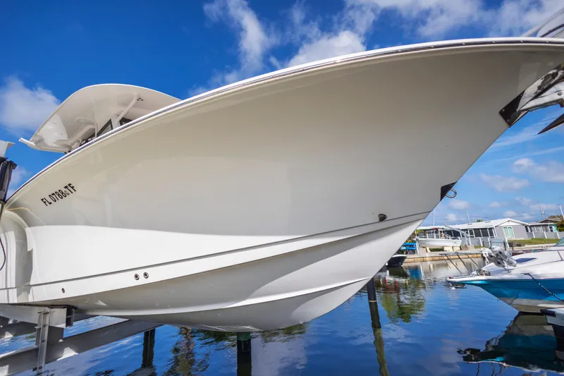 Slide: The Image of 2022 Sea Hunt Gamefish 30 boat on lift, clear sky background. - 20