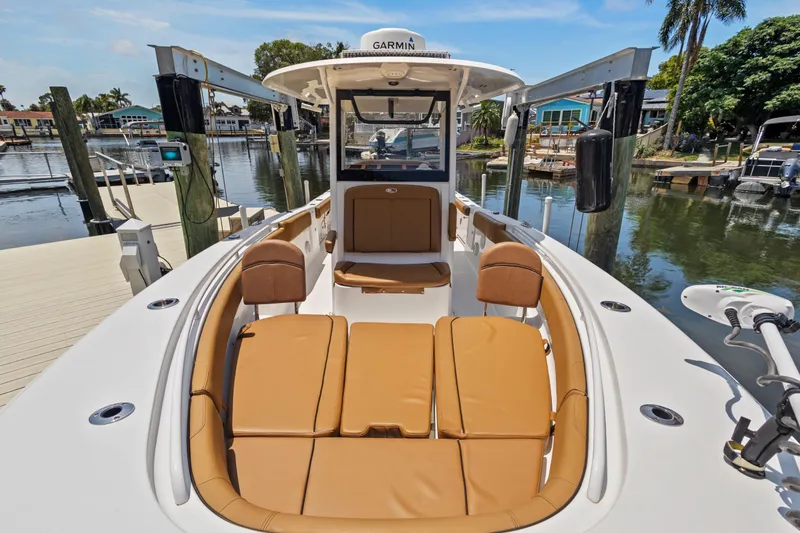 Slide: The Image of 2022 Sea Hunt Gamefish 30 boat with forward seating at a marina dock. - 28