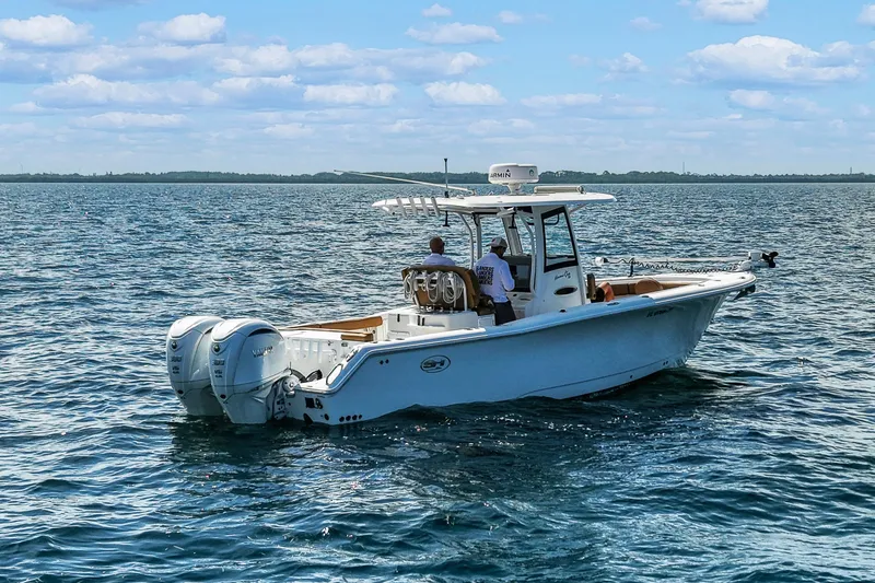 Slide: The Image of 2022 Sea Hunt Gamefish 30 boat on open water, featuring dual engines and forward seating. - 3