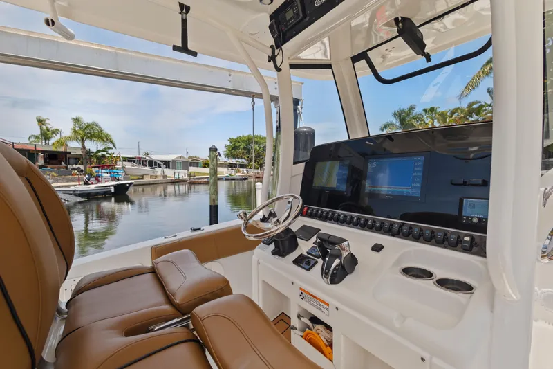 Slide: The Image of 2022 Sea Hunt Gamefish 30 boat interior with advanced navigation system and comfortable seating. - 36