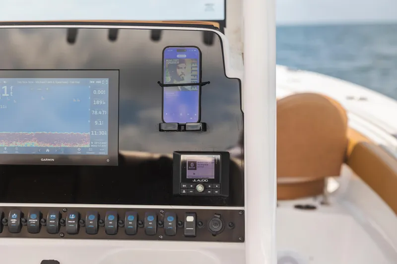 Slide: The Image of Control panel of 2022 Sea Hunt Gamefish 30 boat with Garmin display and phone holder. - 37