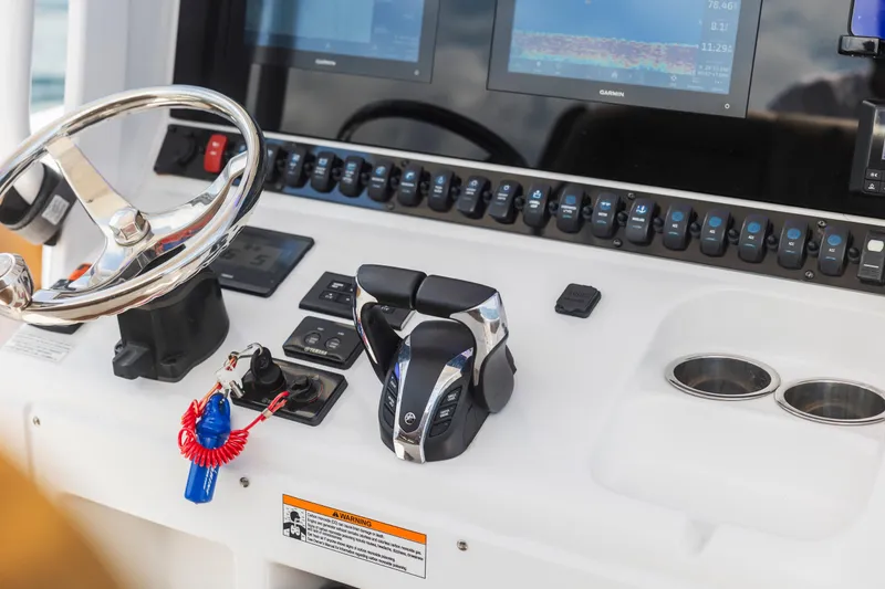 Slide: The Image of Control panel of 2022 Sea Hunt Gamefish 30 boat with steering wheel and electronic displays. - 39