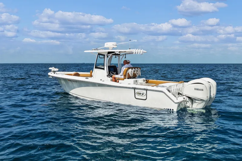 Slide: The Image of 2022 Sea Hunt Gamefish 30 boat on open ocean, clear sky background. - 4