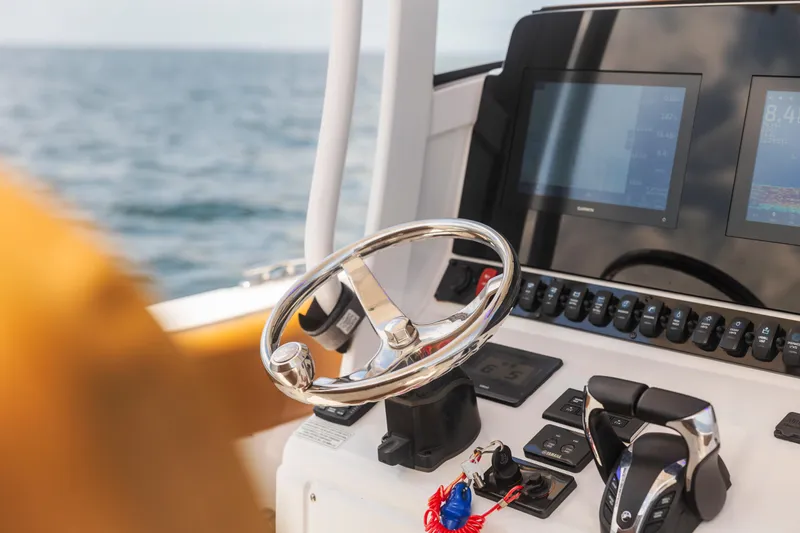 Slide: The Image of Steering console of 2022 Sea Hunt Gamefish 30 boat with modern controls and ocean view. - 40