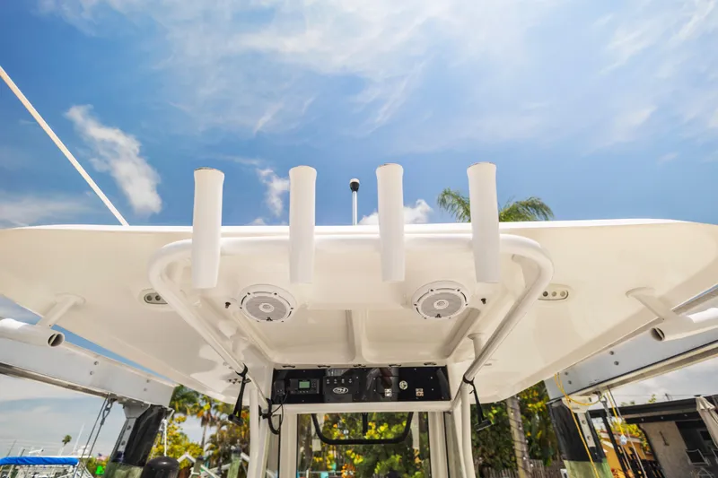 Slide: The Image of 2022 Sea Hunt Gamefish 30 boat roof with rod holders under clear sky. - 45