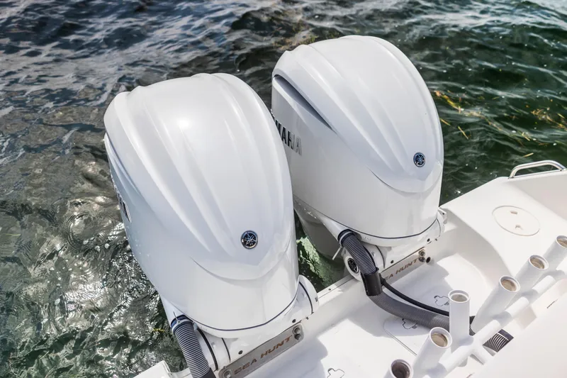 Slide: The Image of Twin Yamaha outboard engines on a 2022 Sea Hunt Gamefish 30 boat in water. - 46