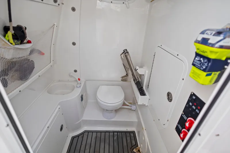 Slide: The Image of 2022 Sea Hunt Gamefish 30 boat interior with toilet and storage features. - 49