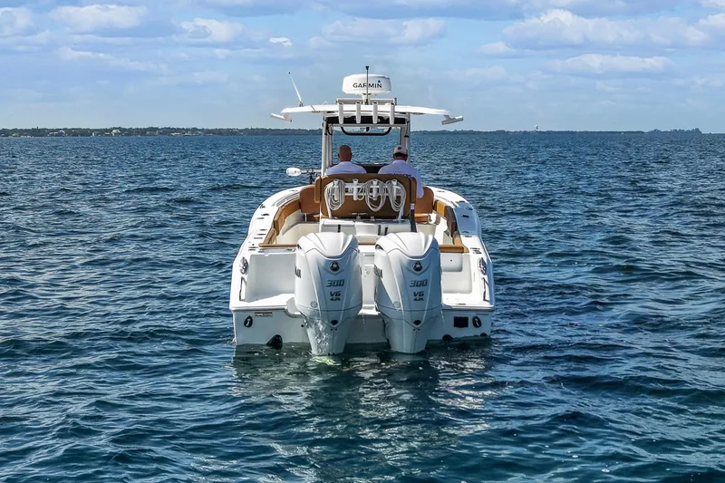 Slide: The Image of 2022 Sea Hunt Gamefish 30 boat on open water, rear view with dual engines. - 5