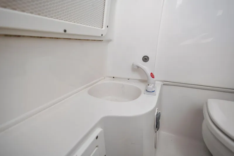 Slide: The Image of 2022 Sea Hunt Gamefish 30 boat bathroom with sink and toilet. - 50