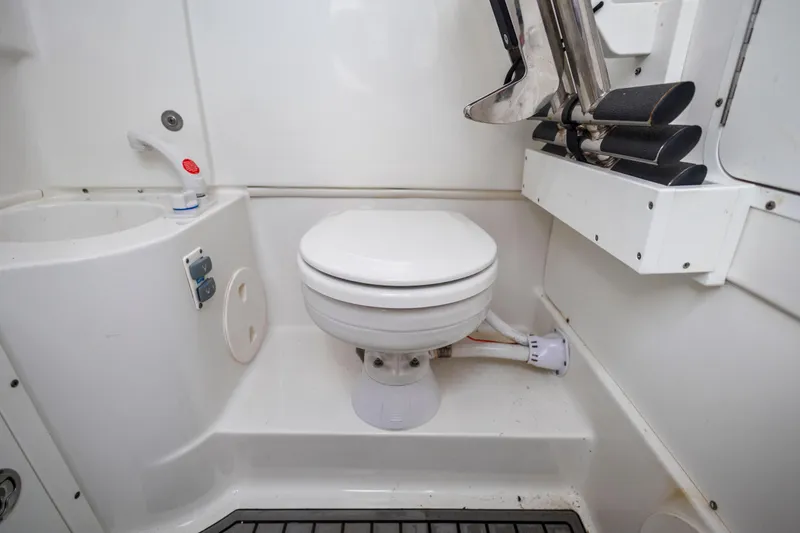 Slide: The Image of 2022 Sea Hunt Gamefish 30 boat bathroom with toilet and sink. - 52