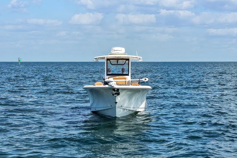 Slide: The Image of 2022 Sea Hunt Gamefish 30 boat on open water under blue sky. - 6