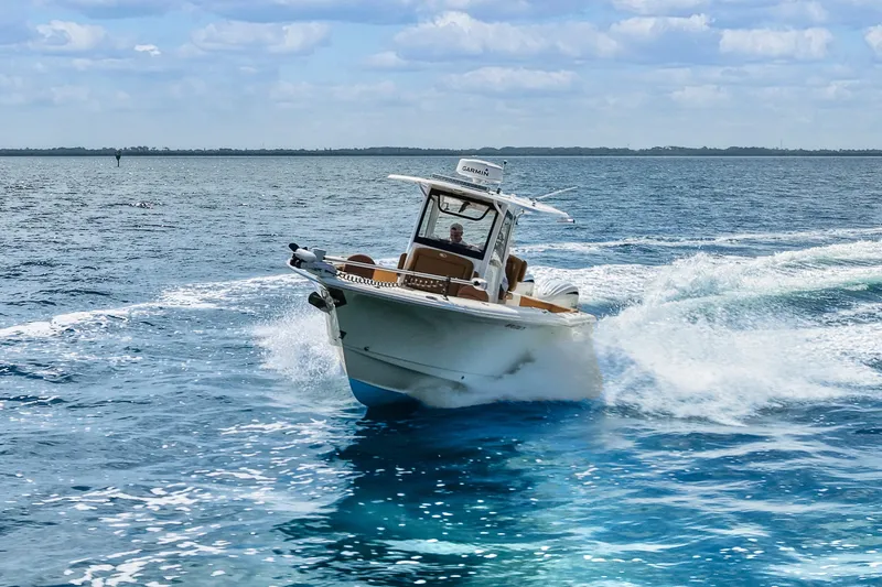 Slide: The Image of 2022 Sea Hunt Gamefish 30 cruising on open water, creating a dynamic wake. - 7