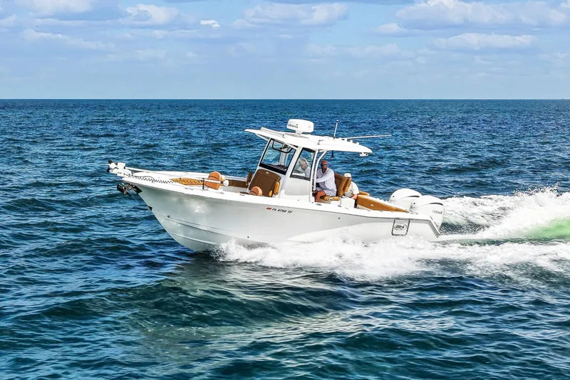 Slide: The Image of 2022 Sea Hunt Gamefish 30 cruising on open ocean under clear skies. - 8