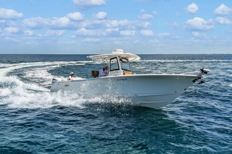 Slide: The Image of 2022 Sea Hunt Gamefish 30 cruising on open ocean under clear skies. - 9