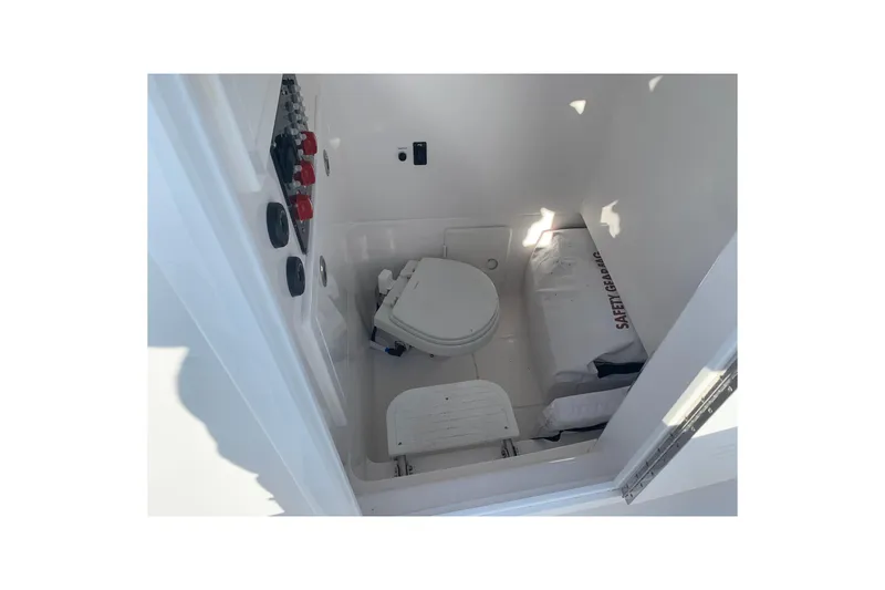 Slide: The Image of Interior of 2020 Belzona 27 CC boat showing compact marine toilet and safety gear. - 20