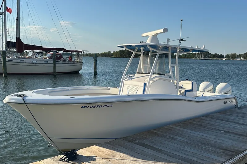 The Image of 2020 Belzona 27 CC boat docked by the water on a sunny day. - 0
