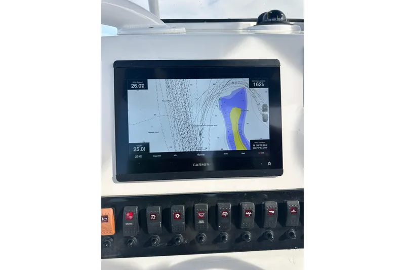 Slide: The Image of Garmin navigation display on 2020 Belzona 27 CC boat dashboard, showing nautical chart. - 27