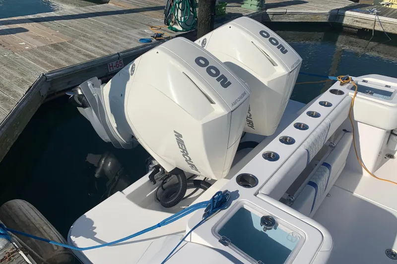 Slide: The Image of 2020 Belzona 27 CC boat with twin Mercury outboard engines docked at marina. - 8