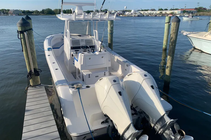 Slide: The Image of 2020 Belzona 27 CC boat docked with dual outboard engines. - 9
