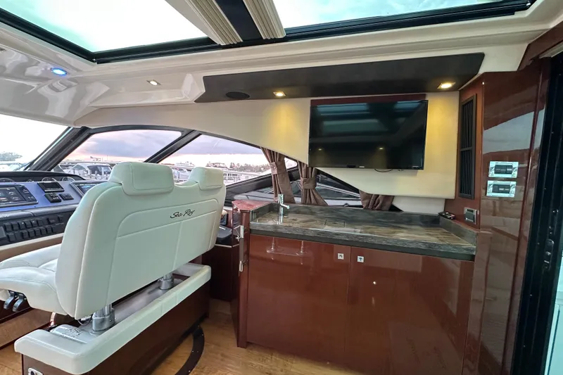 Slide: The Image of Interior of 2014 Sea Ray Sundancer 510 yacht with helm, seating, and entertainment area. - 10
