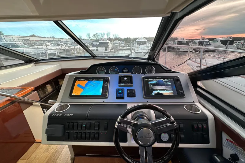 Slide: The Image of Helm of 2014 Sea Ray Sundancer 510 yacht with navigation screens at sunset. - 13