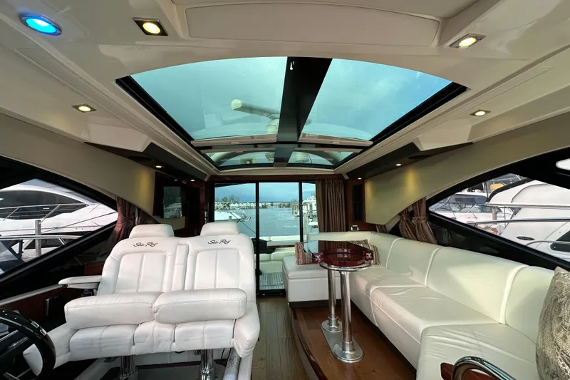 Slide: The Image of Luxurious interior of 2014 Sea Ray Sundancer 510 yacht with white seating and panoramic windows. - 15