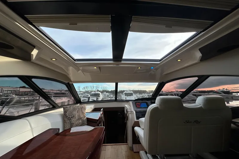 Slide: The Image of Luxurious interior of 2014 Sea Ray Sundancer 510 yacht with panoramic windows and plush seating. - 16