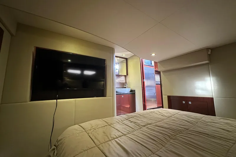 Slide: The Image of Luxurious interior of 2014 Sea Ray Sundancer 510 yacht with TV and cozy bedding. - 26