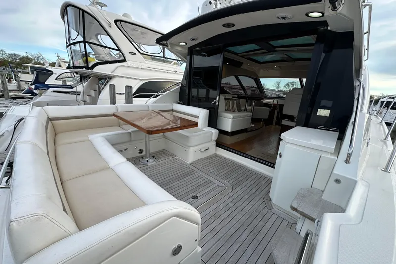 Slide: The Image of 2014 Sea Ray Sundancer 510 yacht with spacious outdoor seating and elegant interior. - 3