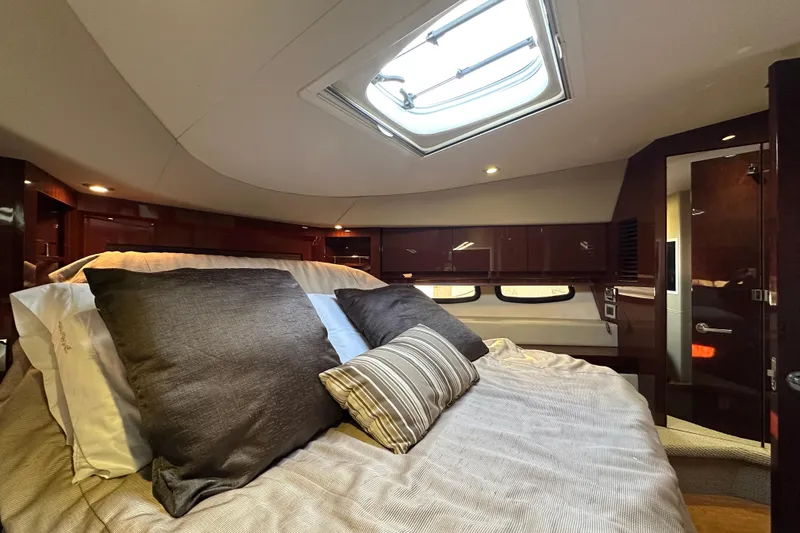 Slide: The Image of Luxurious cabin interior of 2014 Sea Ray Sundancer 510 yacht with skylight and plush bedding. - 31