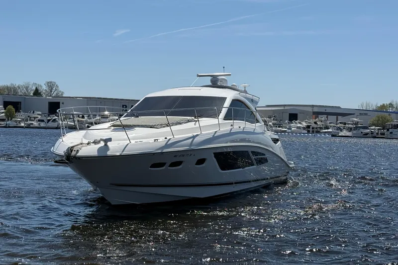 Slide: The Image of 2014 Sea Ray Sundancer 510 yacht cruising on a sunny day near a marina. - 38