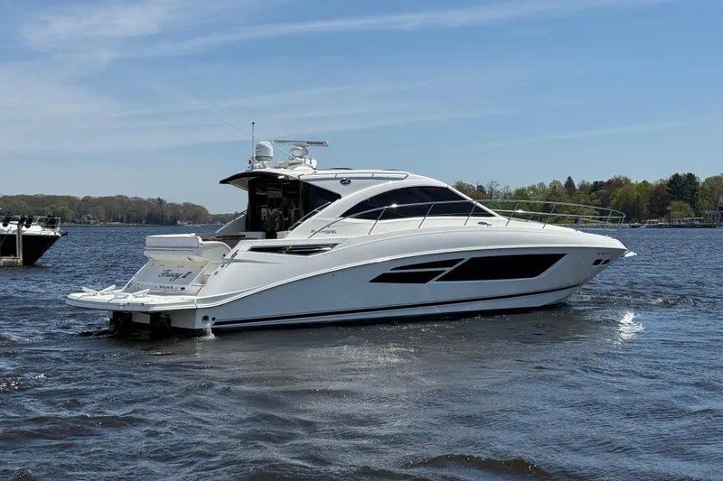 Slide: The Image of 2014 Sea Ray Sundancer 510 yacht cruising on a calm lake under a clear blue sky. - 41
