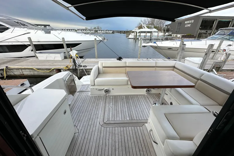 Slide: The Image of Luxurious 2014 Sea Ray Sundancer 510 yacht with spacious deck seating and table at marina. - 5