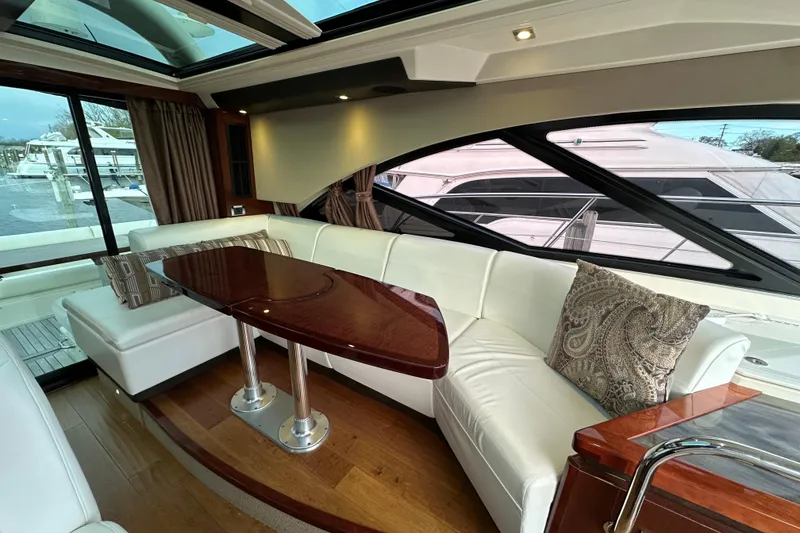 Slide: The Image of Luxurious interior of 2014 Sea Ray Sundancer 510 yacht with elegant seating and wooden table. - 9