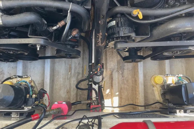 Slide: The Image of Engine compartment of a 1998 Fountain 29 Fever boat, showing belts and hoses. - 12