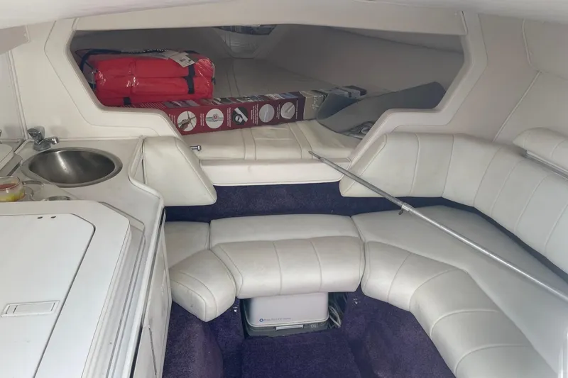 Slide: The Image of Interior of a 1998 Fountain 29 Fever boat with white seating and compact kitchenette. - 15