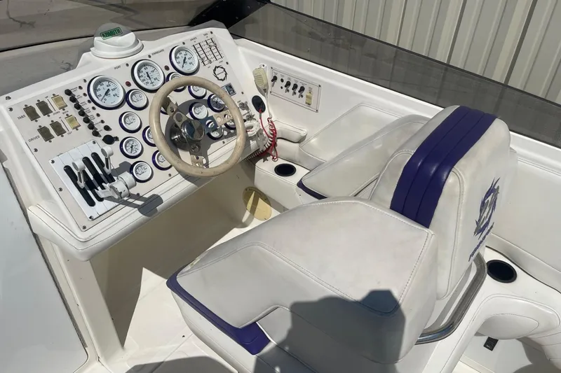 Slide: The Image of Cockpit of a 1998 Fountain 29 Fever boat with gauges and controls. - 18
