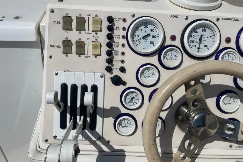 Slide: The Image of Control panel of a 1998 Fountain 29 Fever boat with gauges and switches. - 21