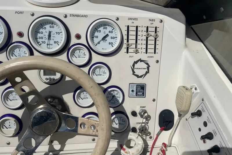 Slide: The Image of 1998 Fountain 29 Fever boat dashboard with gauges and controls. - 22
